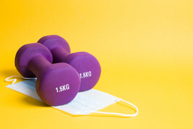 purple-dumbbells-on-a-medical-protective-mask-on-a-yellow-surface signs of a strong immune system